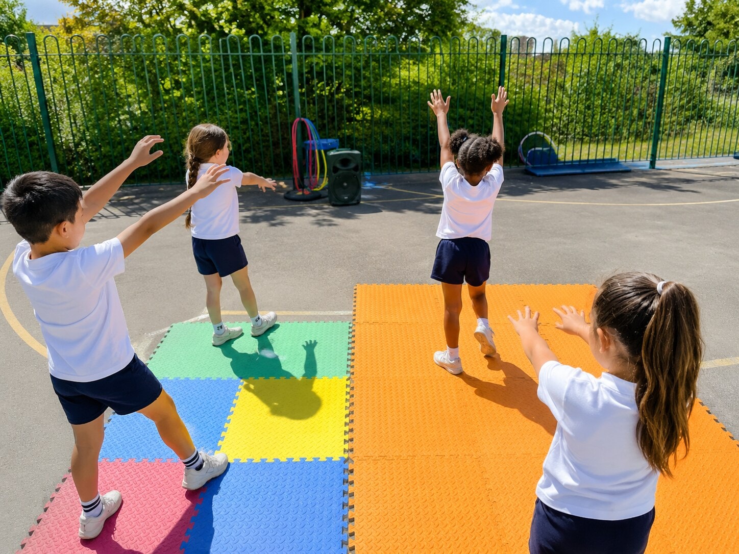 Children doing energetic group movement on colourful mats outdoors