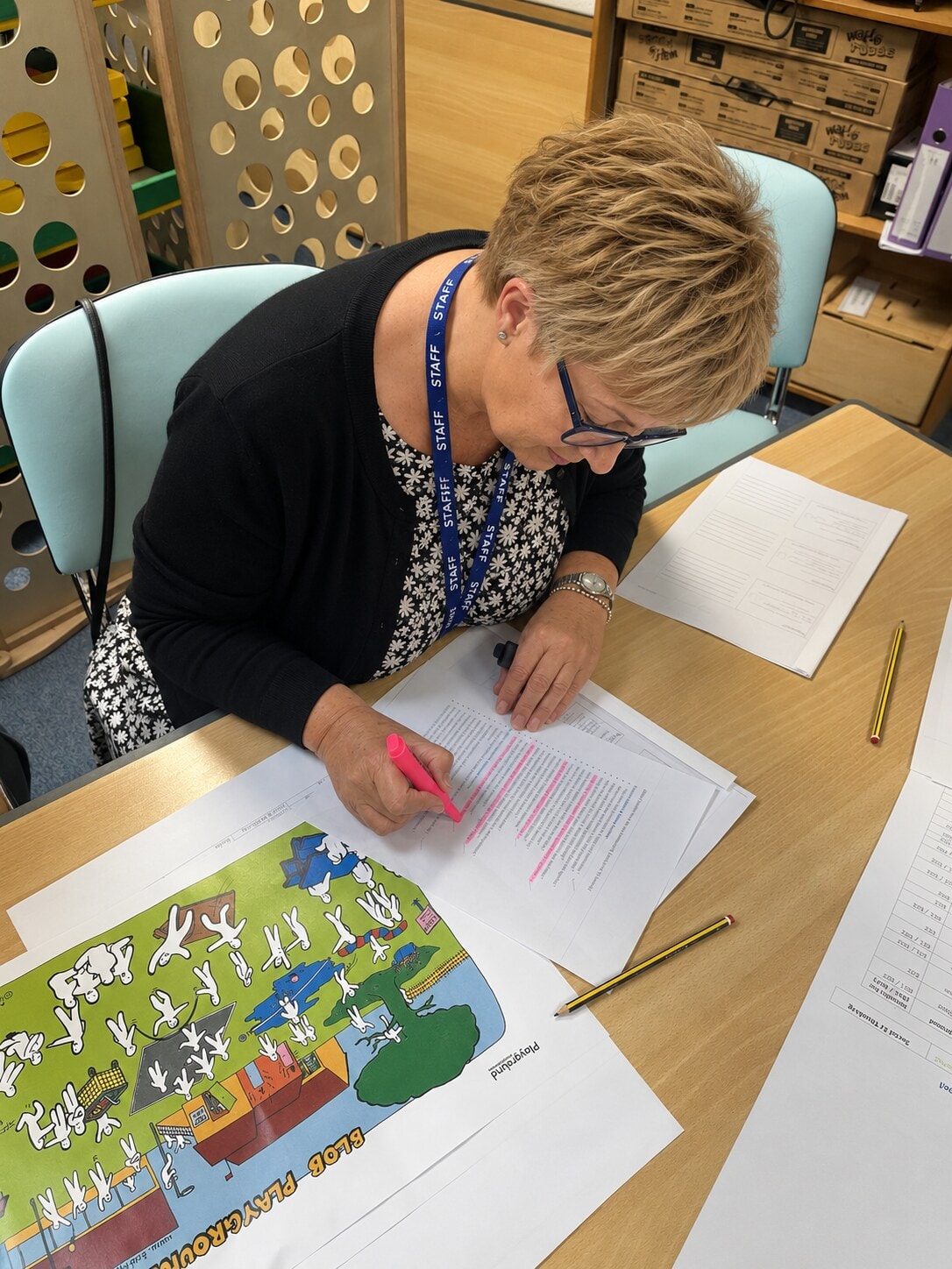 Two staff members sitting side by side reviewing the Blob Playground resource during training